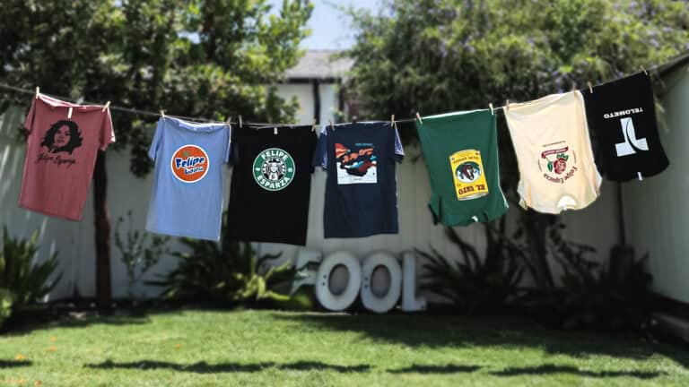 Felipe Esparza merch T-shirts hanging from a close line in a backyard